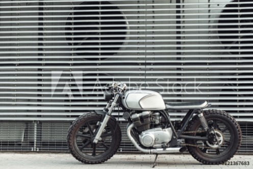 Picture of Motorcycle standing in dark building in rays of sunlight